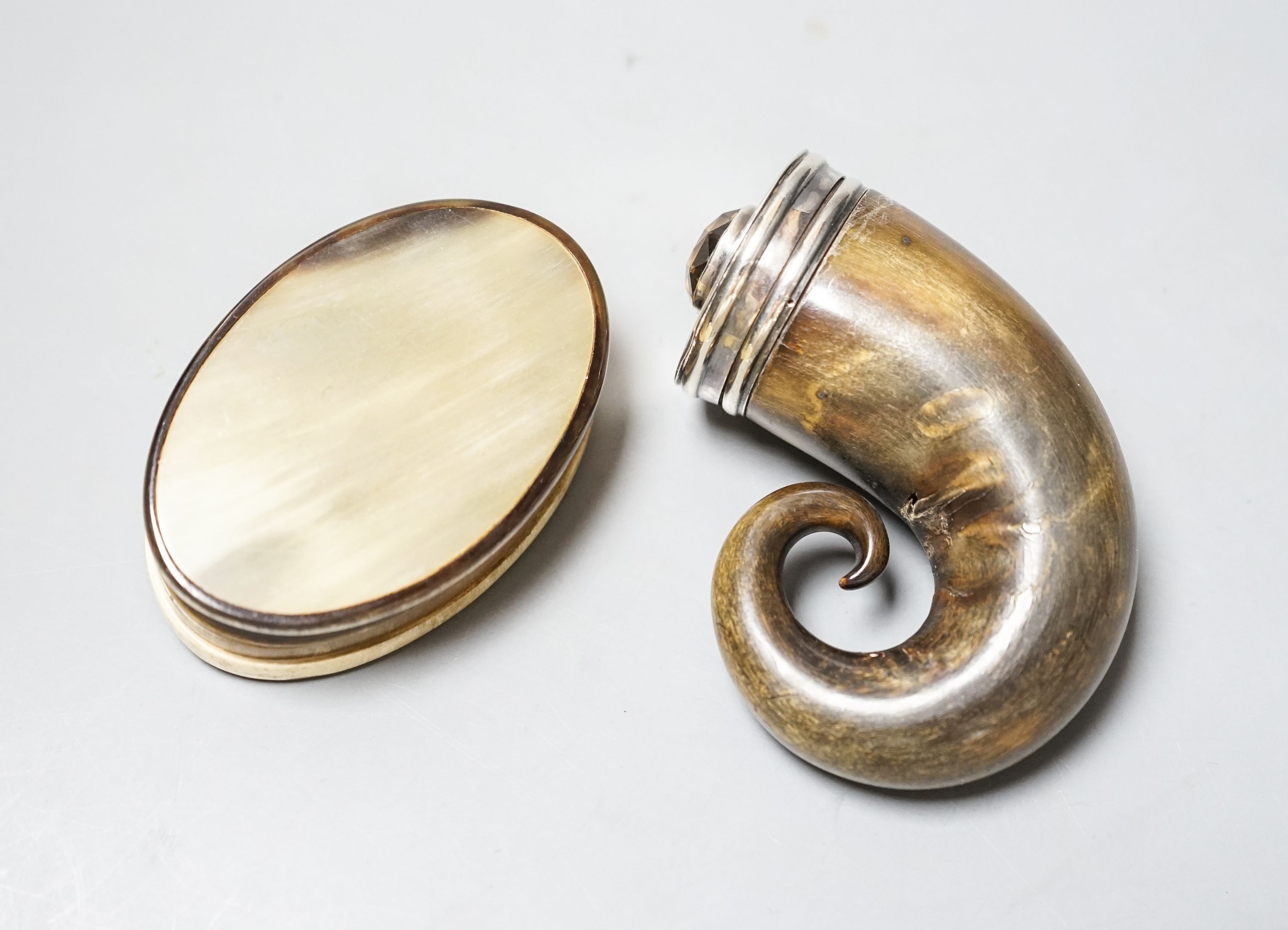 A 19t century white metal and gem set mounted horn snuff mull(a.f.)78mm and a similar oval horn snuff box.
